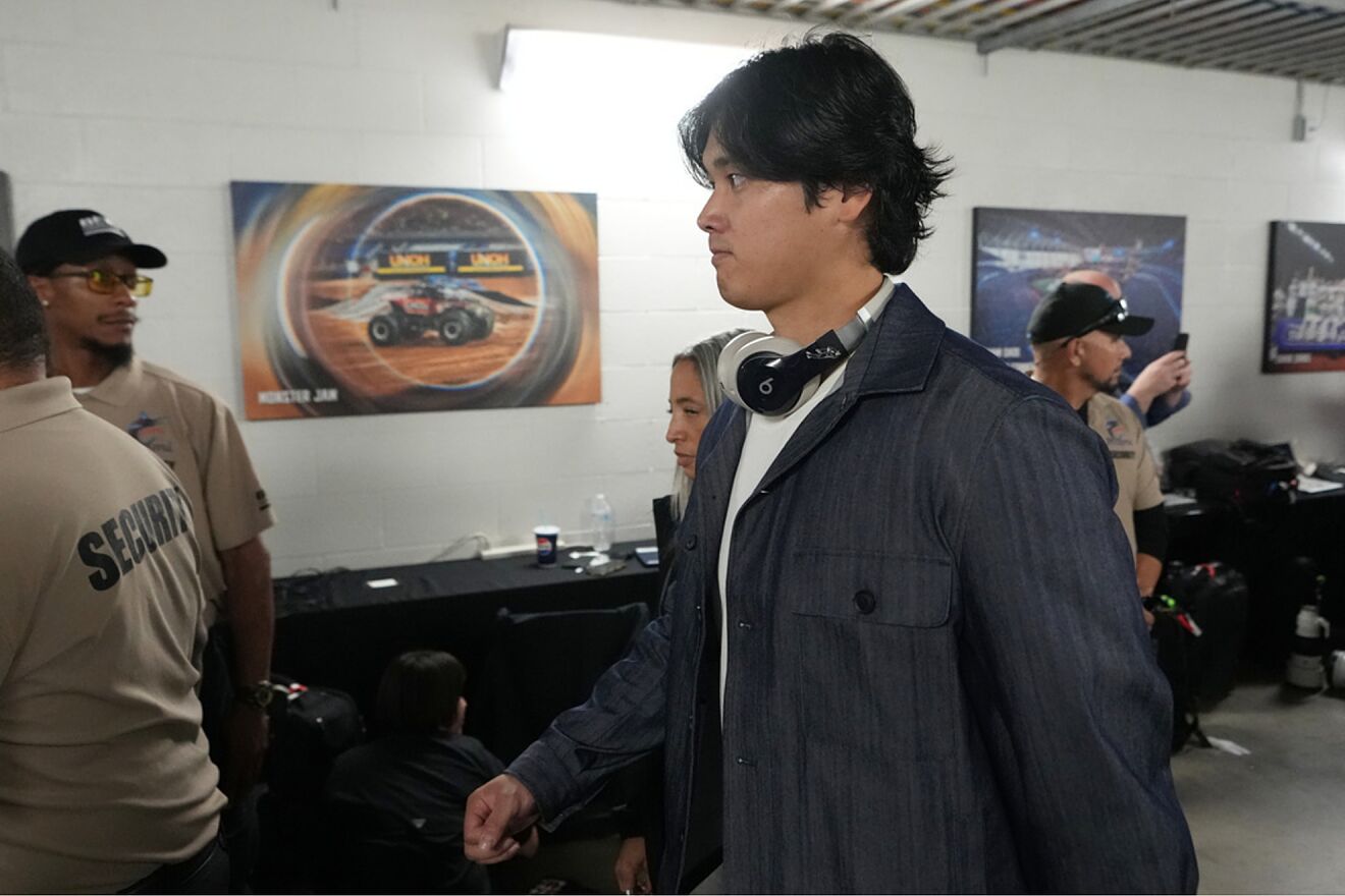 Japan's Shohei Ohtani is escorted by security down a hallway