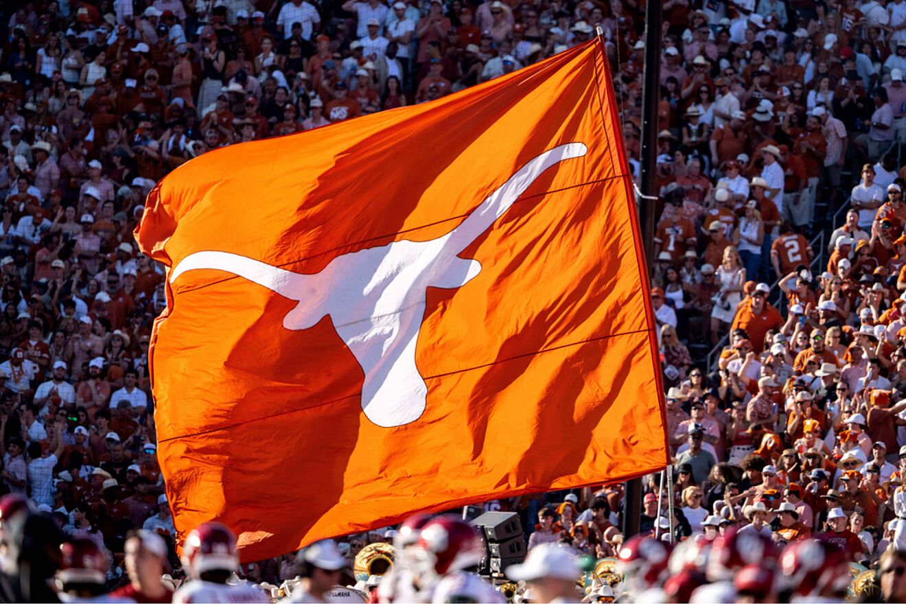 A Texas Longhorns flag is waved