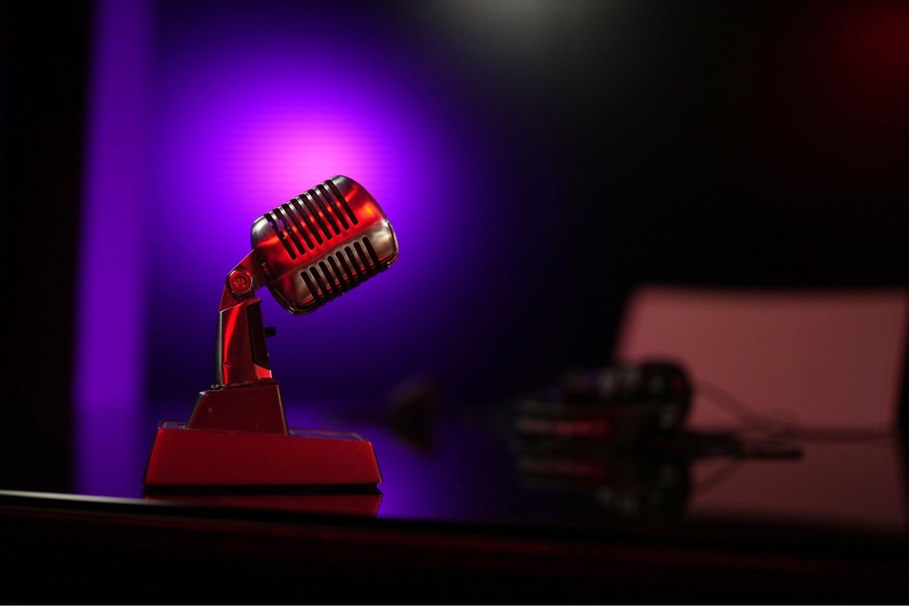 A replica of a microphone is placed in the TV studio set