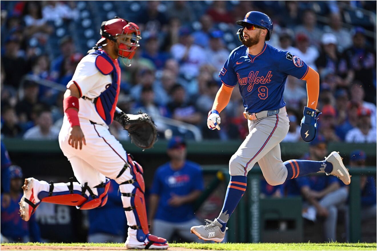 New York Mets' Brandon Nimmo (9) scores on a sacrifice fly hit by Jeff...