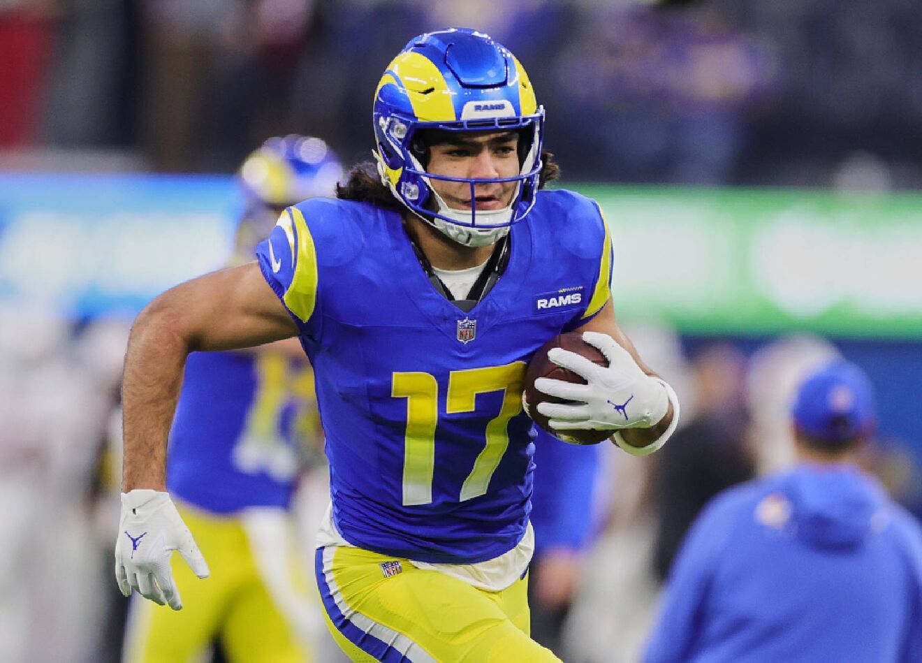 Puka Nacua runs with the ball during a Los Angeles Rams game.