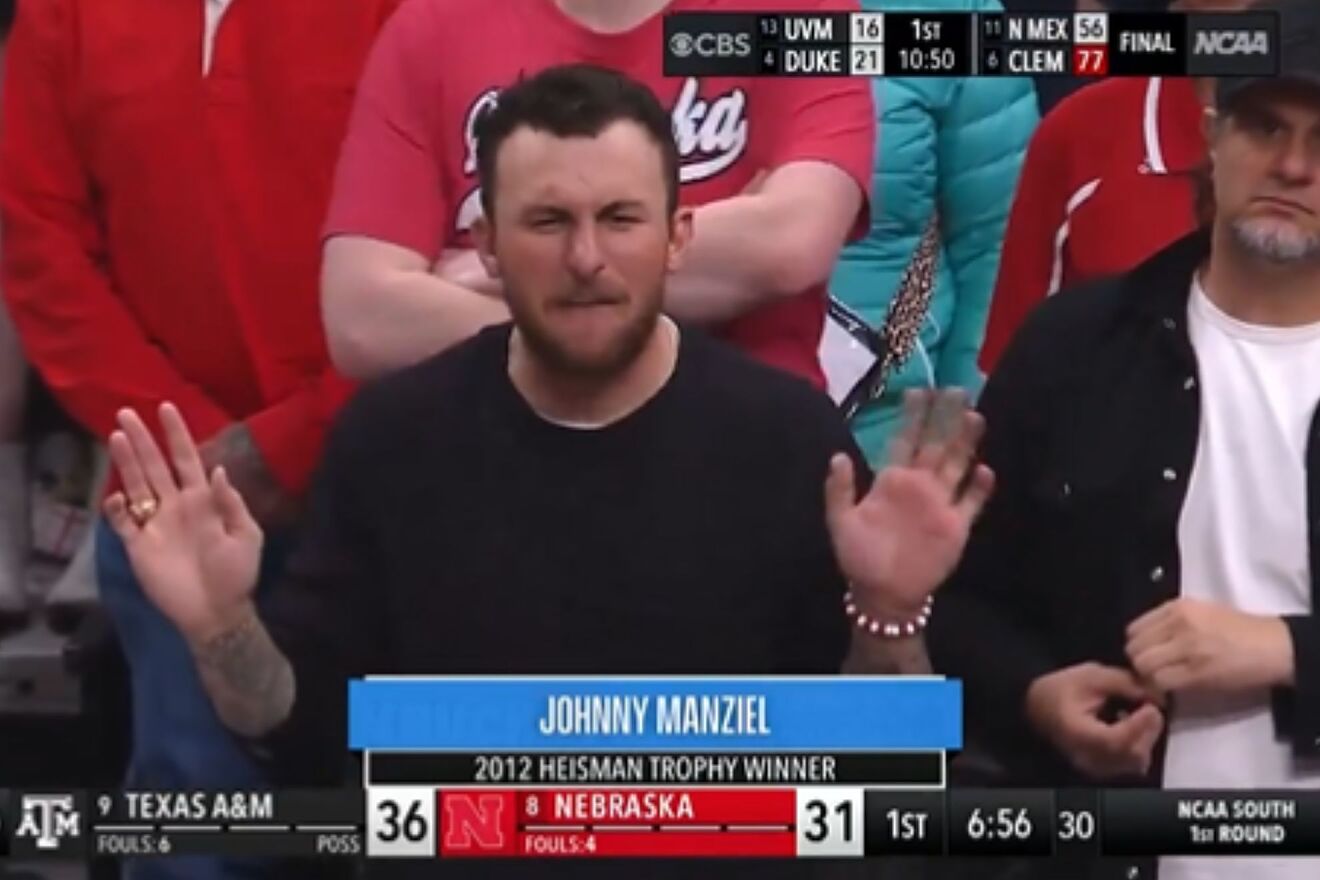 Johnny Manziel sits by Nebraska fans while cheering for Texas Aandamp;M...
