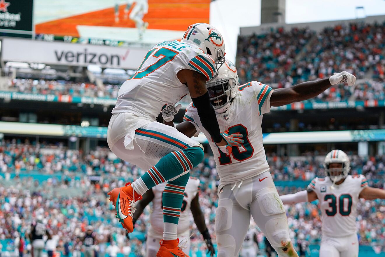 Tyreek Hill and Jaylen Waddle celebrate a touchdown together.