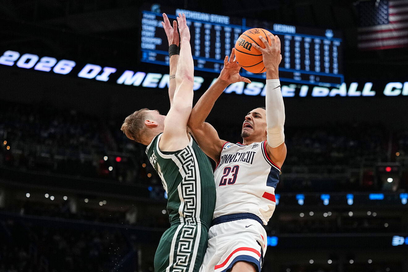 UConn forward Jayden Ross (23) shoots over Michigan State center...
