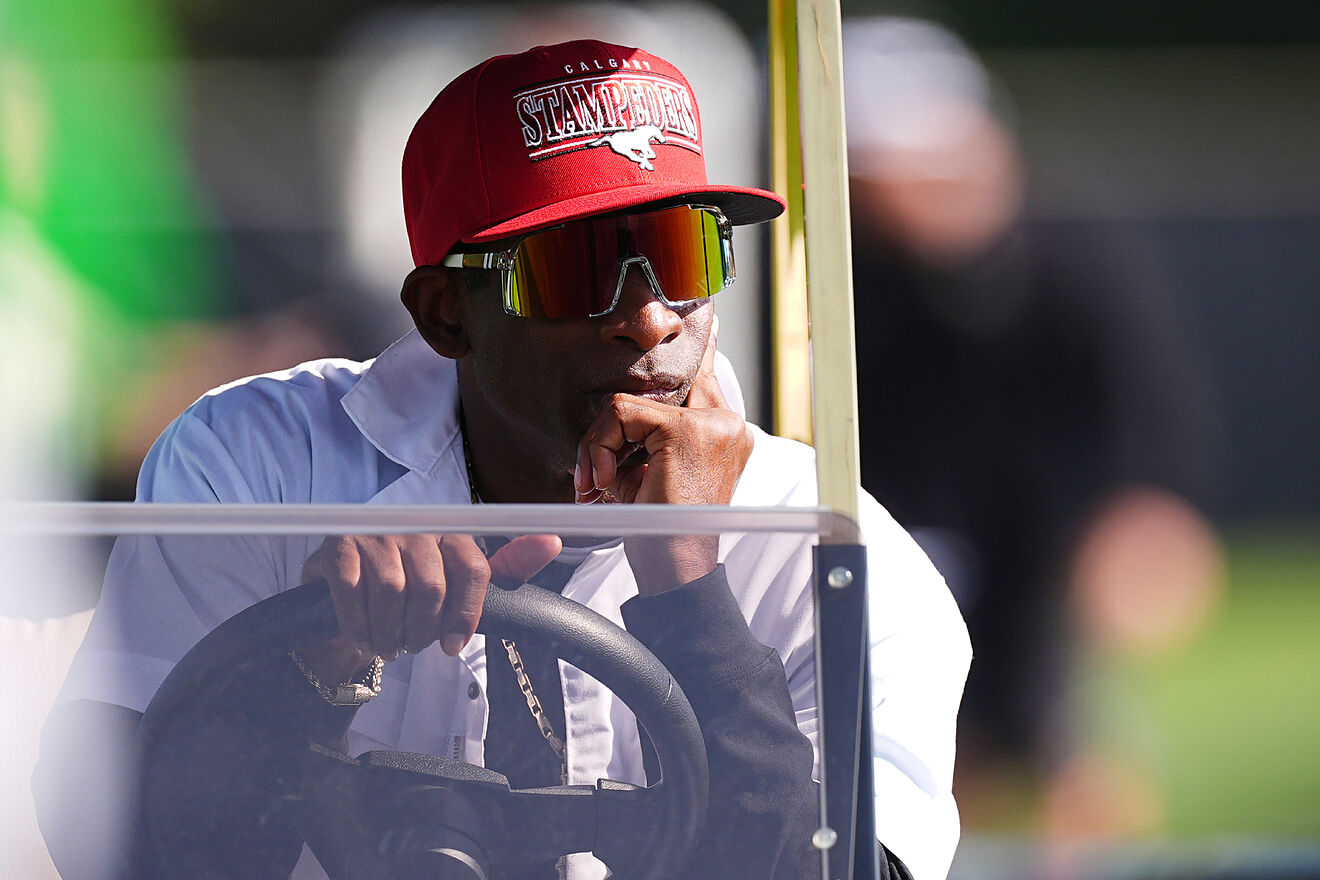 Colorado head coach Deion Sanders looks on from a golf cart as players...