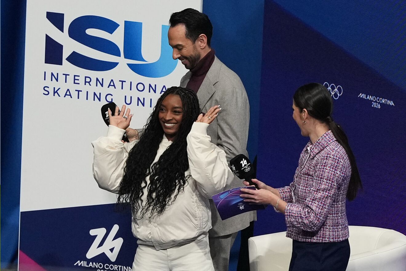 Simone Biles watches competes the men's free skate program in figure...