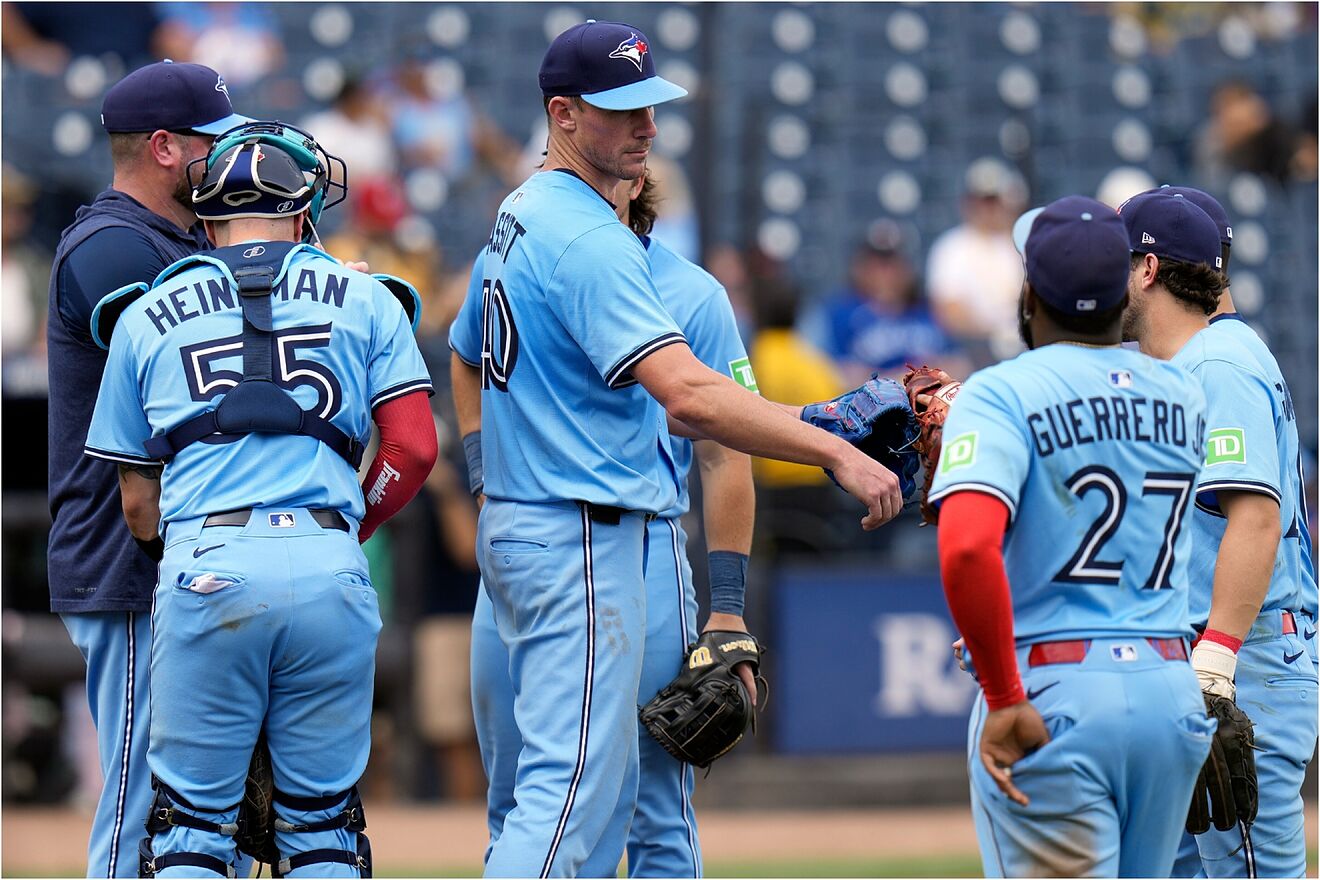 Blue Jays pitcher Chris Bassitt (40) fist bumps teammates after being...
