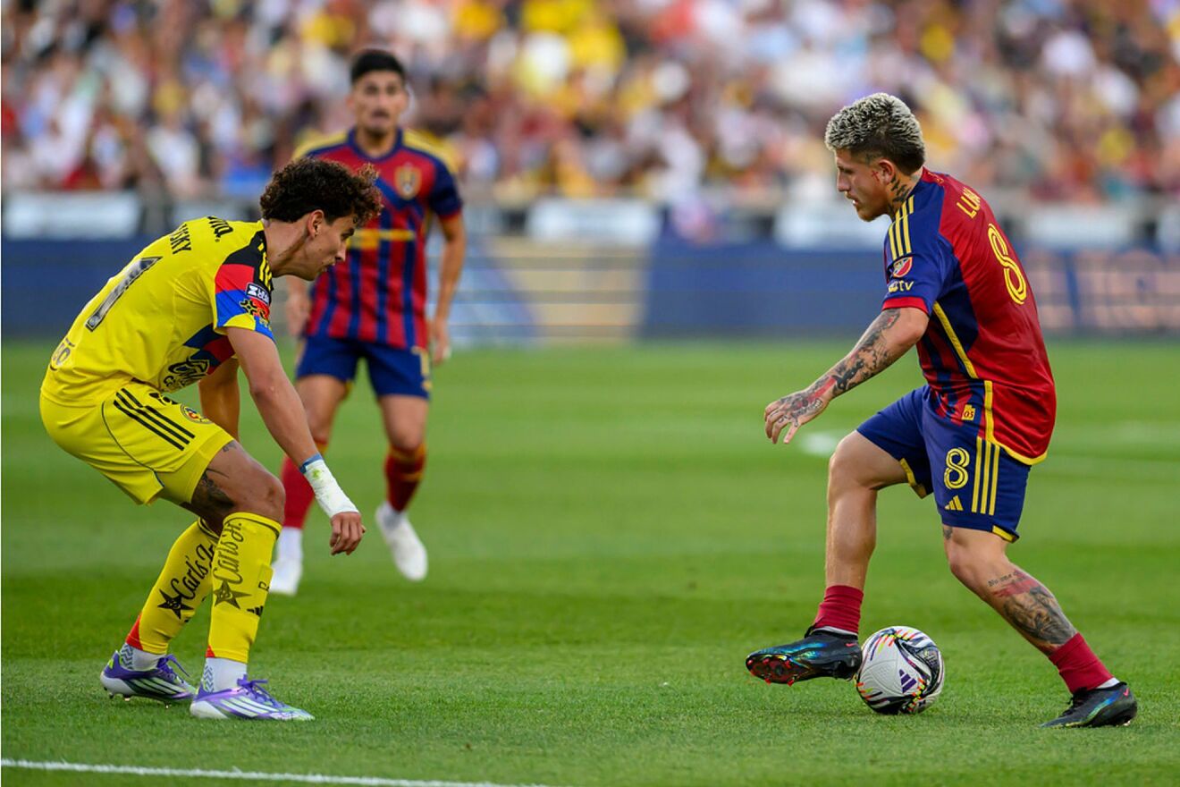 Real Salt Lake midfielder Diego Luna dribbles the ball defended by...