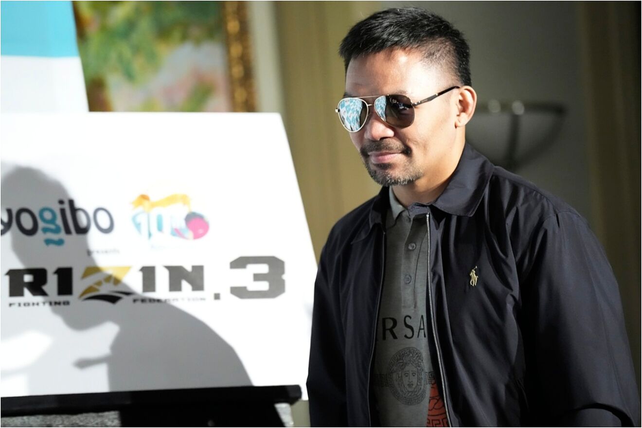 Former Filipino boxer Manny Pacquiao, enters the venue of a press...