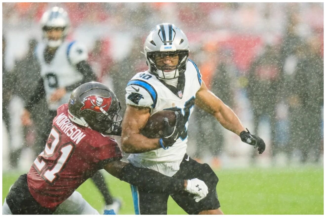 Panthers running back Chuba Hubbard (30) runs around the tackle...
