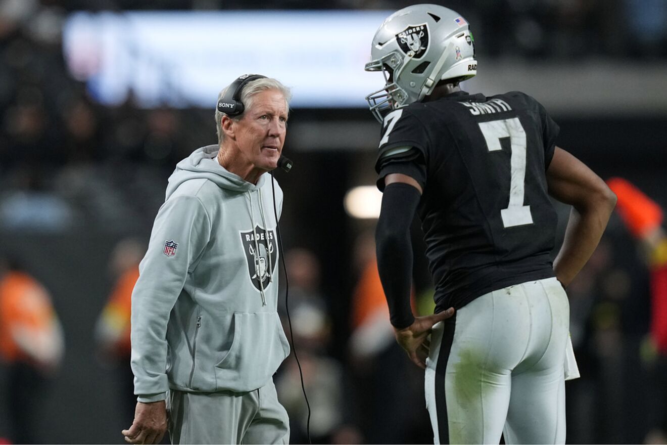 Former Las Vegas Raiders head coach Pete Carroll speaks with former...