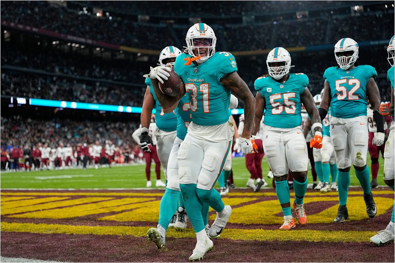 Miami Dolphins running back Ollie Gordon II (31), center, reacts after...