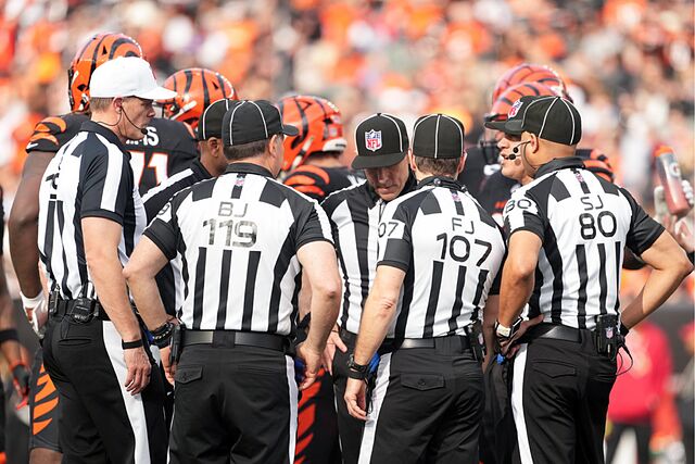 Referee Clay Martin (19), far left, talks with the officiating crew during an NFL football game