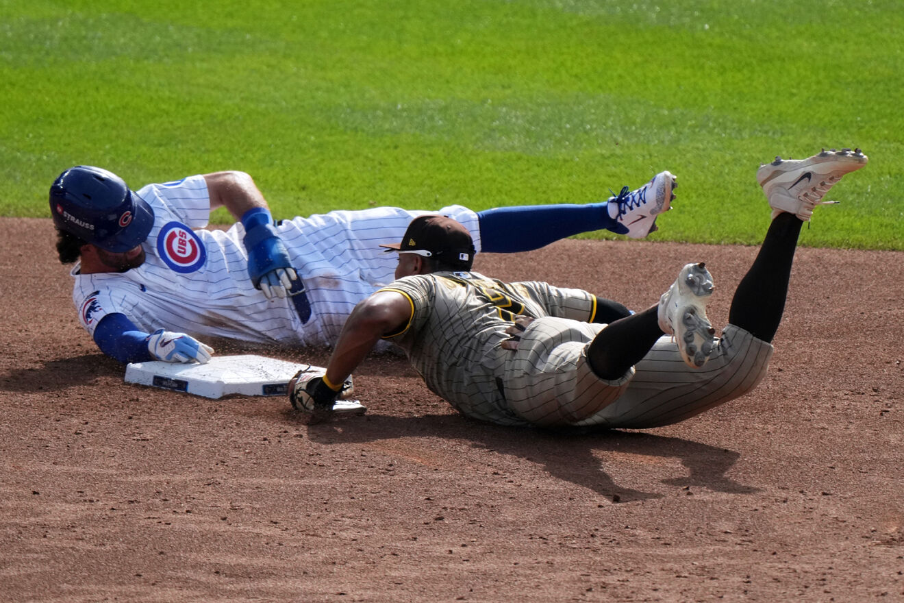 Chicago Cubs' Dansby Swanson slides safely back to second with San...