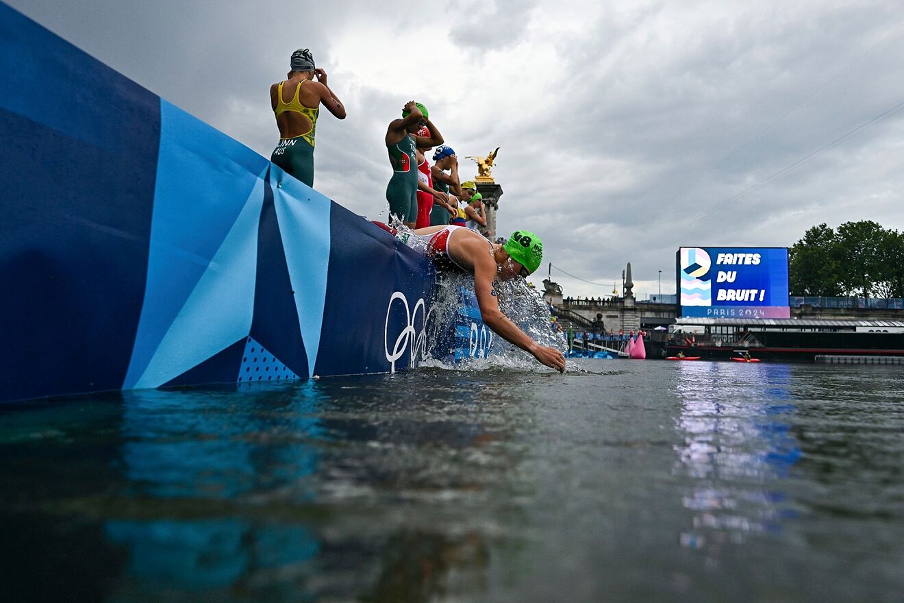 Women triathletes get ready to jump on the Siene River for the Paris...