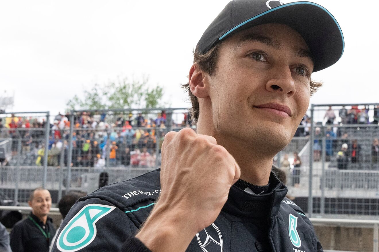 Mercedes driver George Russell celebrates after taking the pole...