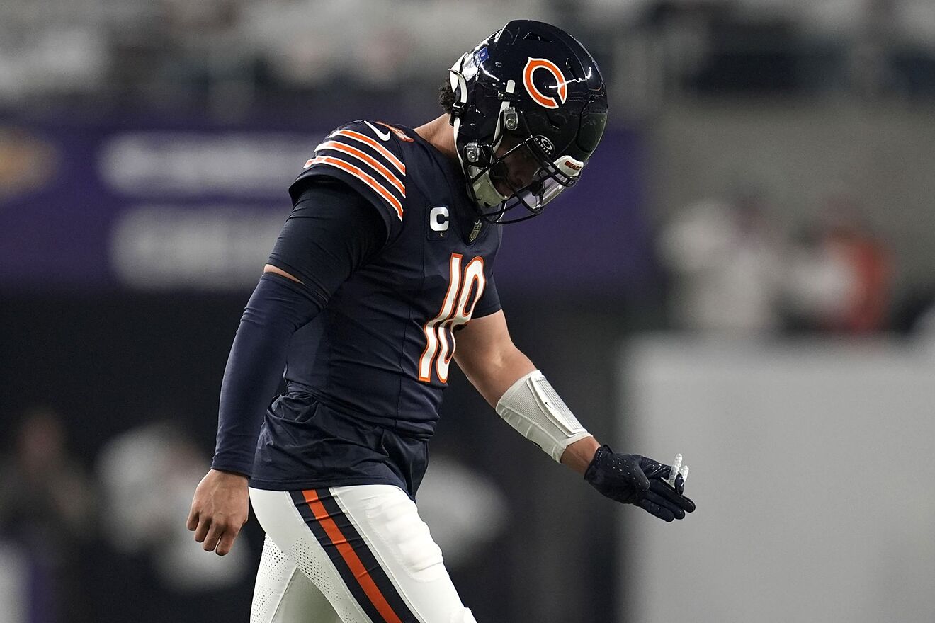 Chicago Bears quarterback Caleb Williams walks off the field after an...