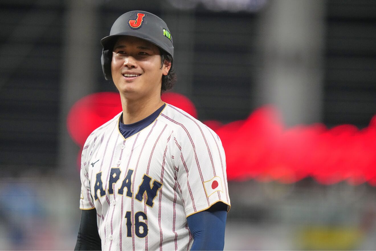 Japan's Shohei Ohtani smiles after is intentionally walked during the...