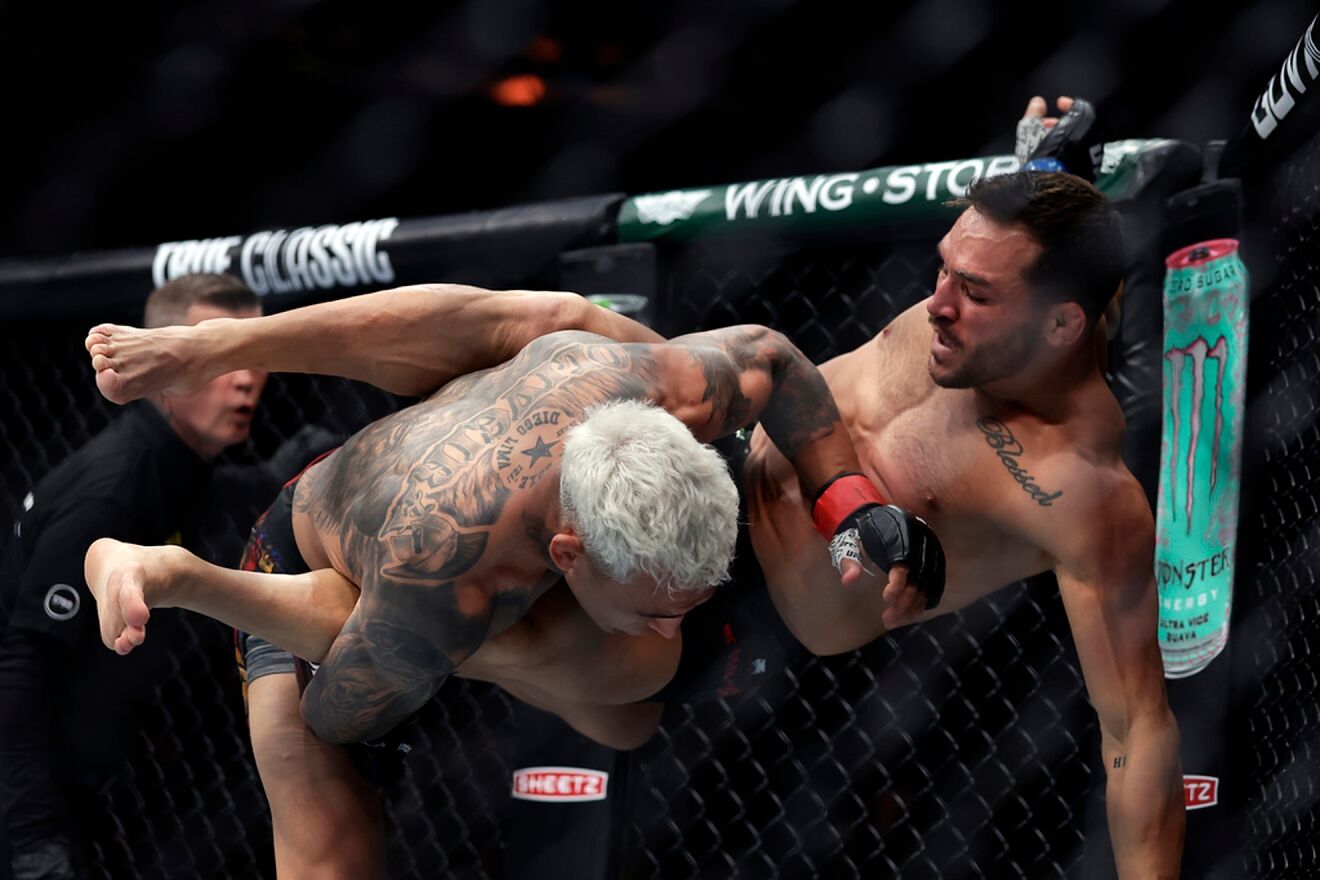 Brazil's Charles Oliveira throws Michael Chandler in a UFC 309 mixed...