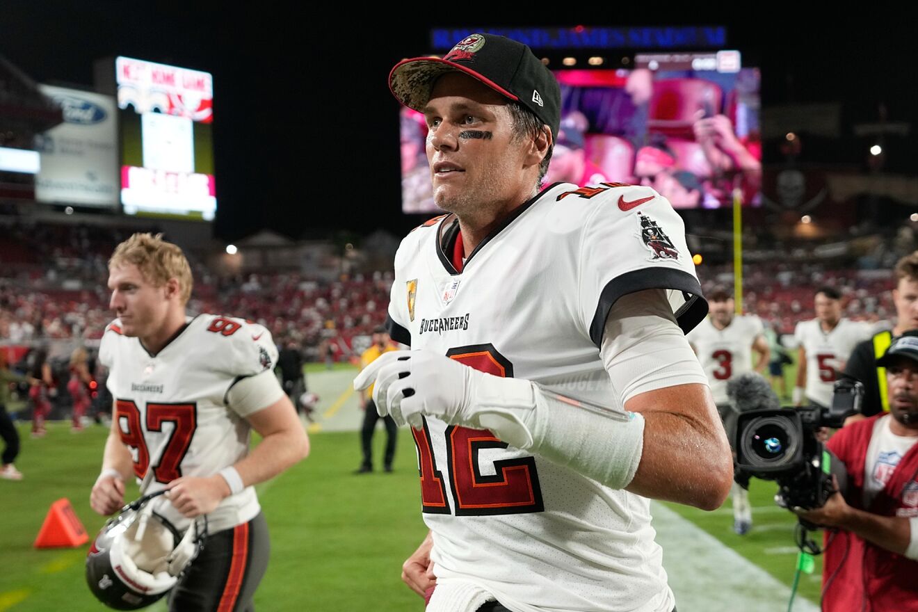 Tom Brady runs off the field after an NFL football game.