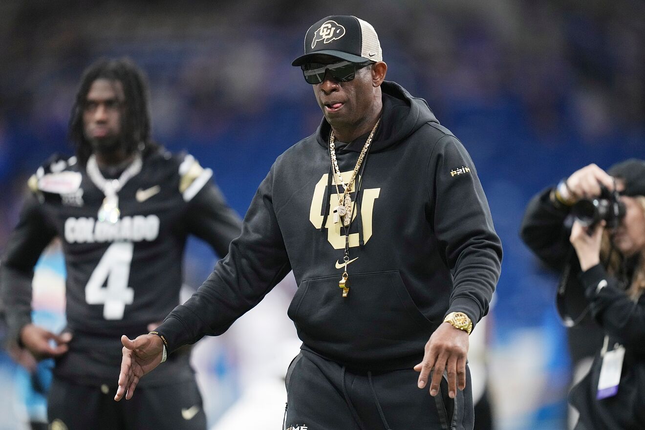 Deion Sanders watches his players warm up for the Alamo Bowl.