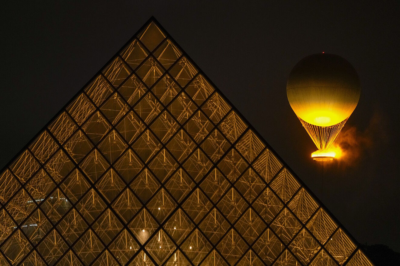 Olympic Flame rises balloon Louvre lit Paris France opening ceremony...