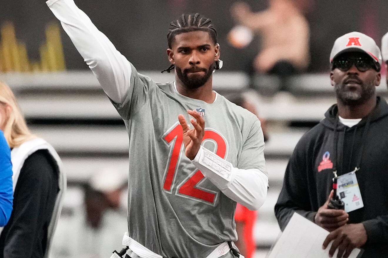 Shedeur Sanders throws a pass while Michael Vick watches on during an...