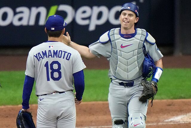 Will Smith and Yoshinobu Yamamoto celebrate after Game 2 of baseball's National League Championship