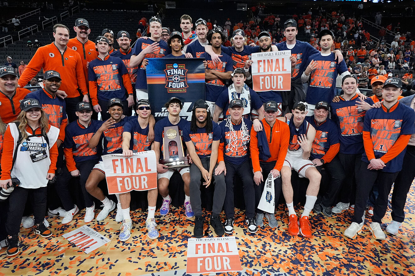 Illinois basketball team members celebrate after beating Iowa
