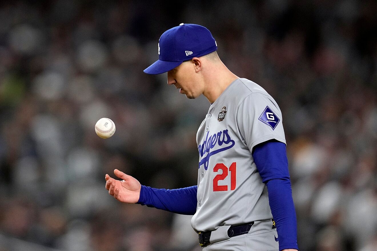 Los Angeles Dodgers starting pitcher Walker Buehler tosses the ball...