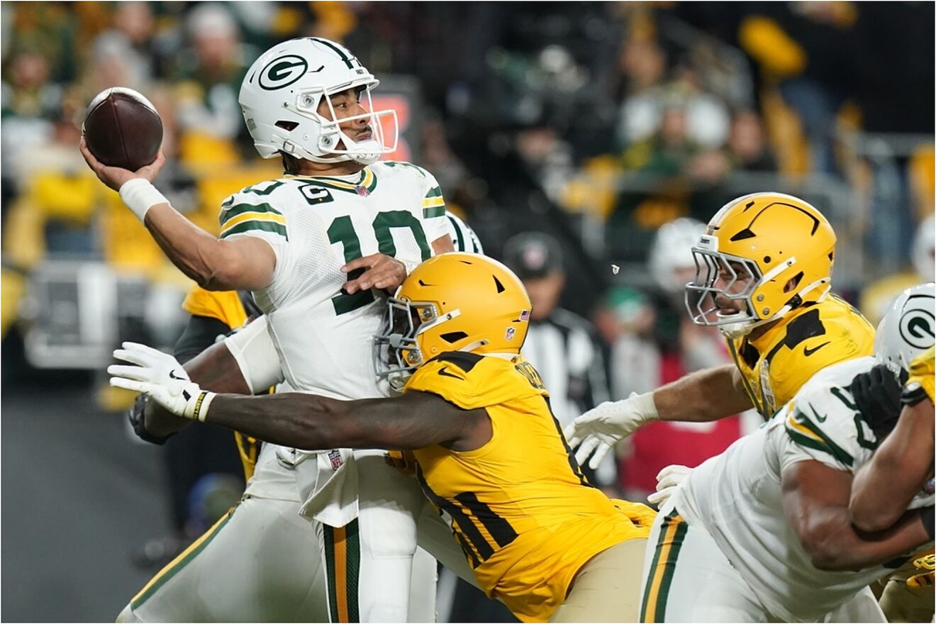 Green Bay Packers' Jordan Love throws as he is hit by Pittsburgh...