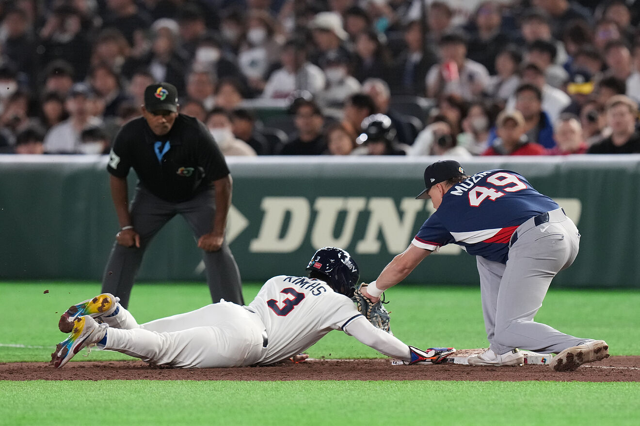 South Korea's Kim Hyeseong, center, slides to first base against Czech...